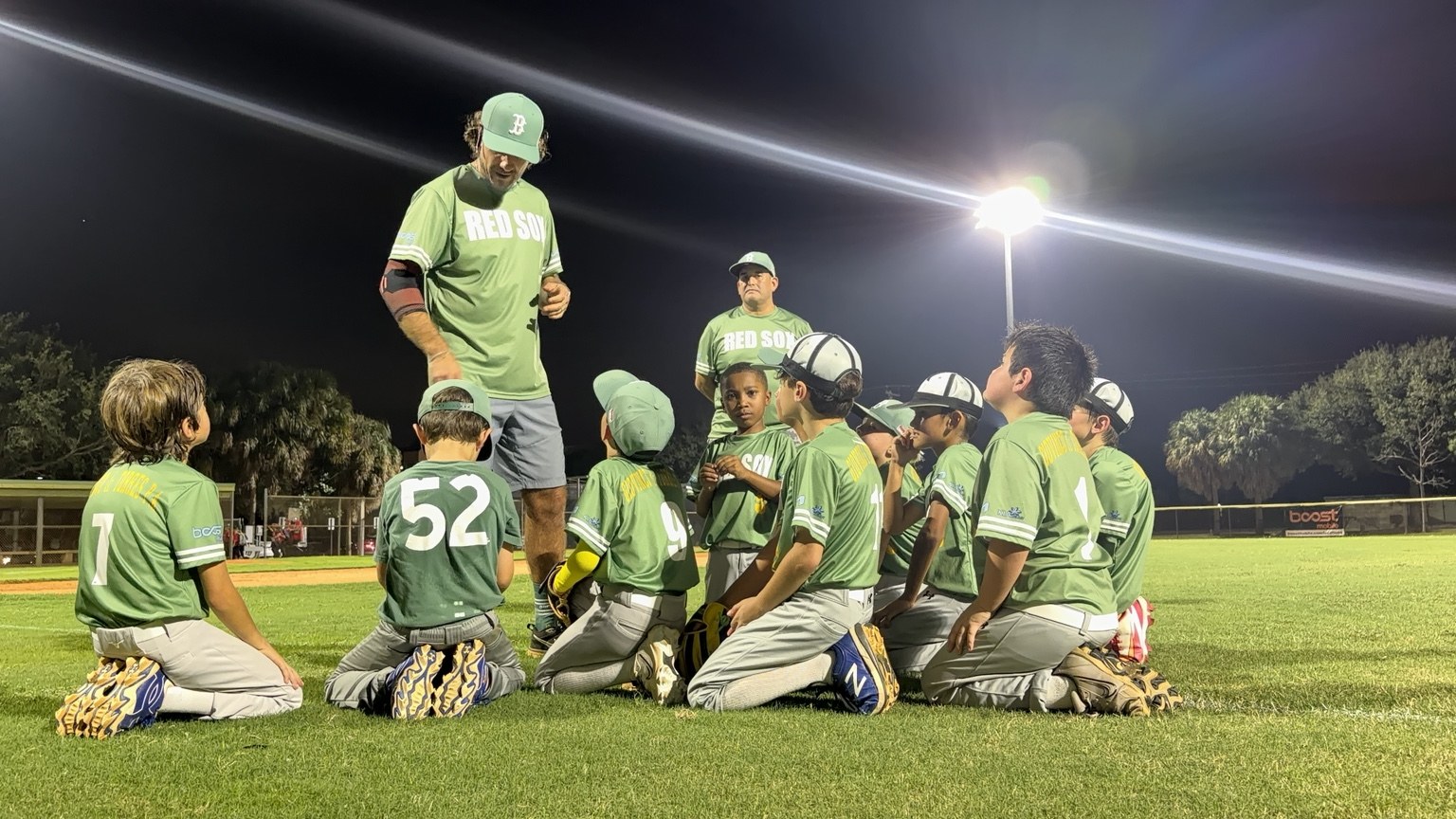 Red Sox teammates gathered under the ballpark lights